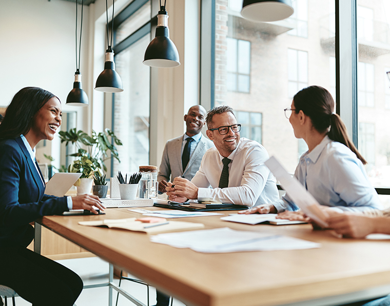 diverse businesspeople laughing during a meeting