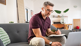 man sitting at laptop