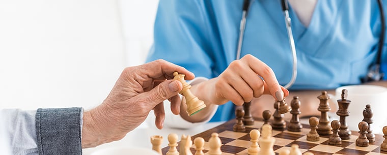 Two senior women playing chess